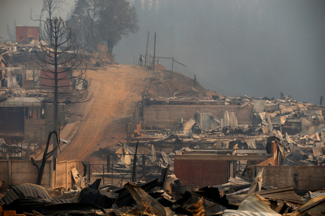 Wreckage of homes destroyed by fire in Santa Olga, Chile, on January 26th, 2017. While the entire town was consumed in the flames, the 6,000 residents reportedly escaped unharmed. Image: Javier Torres/Aton via AP
